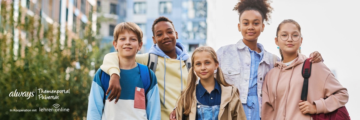 5 kids standing together in front of a building